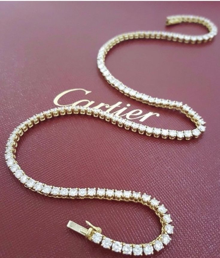 A diamond tennis bracelet displayed on a luxury Cartier box with elegant gold lettering, highlighting how high-end jewelry houses elevated the global popularity of tennis bracelets through refined marketing and iconic presentation.