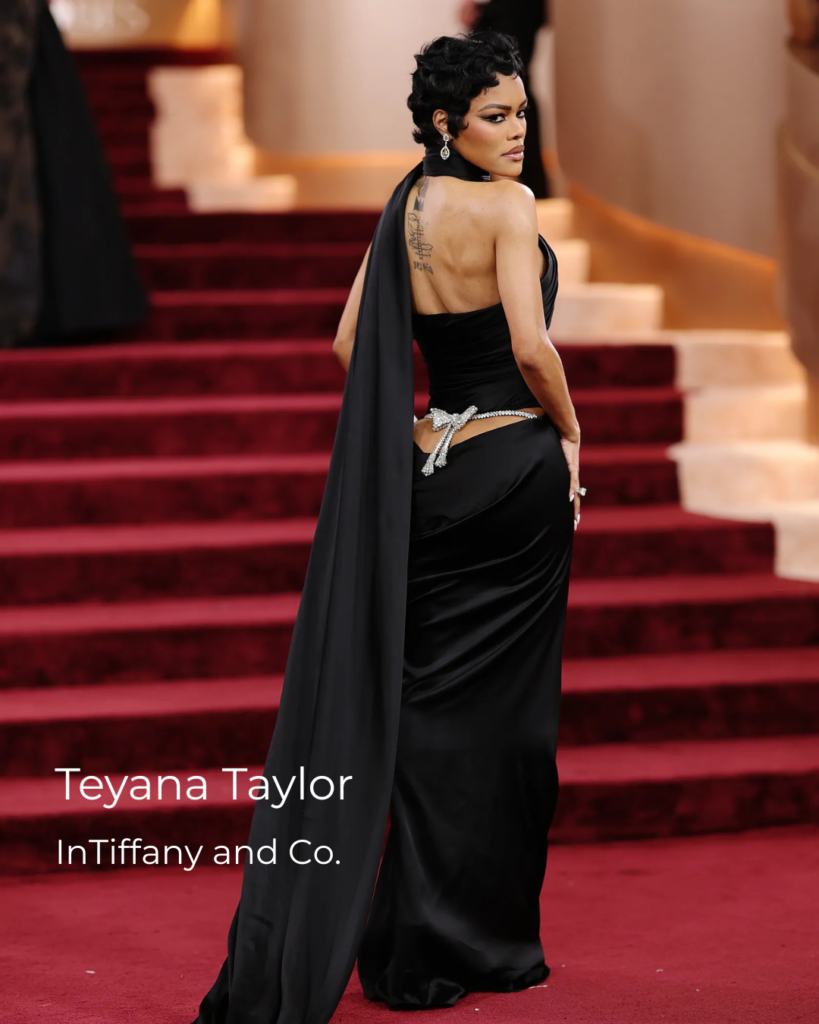 Teyana Taylor at the Golden Globes 2026 red carpet wearing a dramatic oversized bow brooch at the back, highlighting statement high jewelry and red carpet jewelry trends.