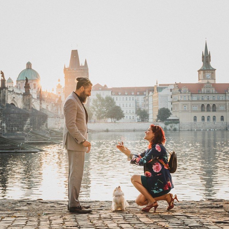 Woman proposing to a man by the river, representing modern proposals and the rise of men’s engagement rings.