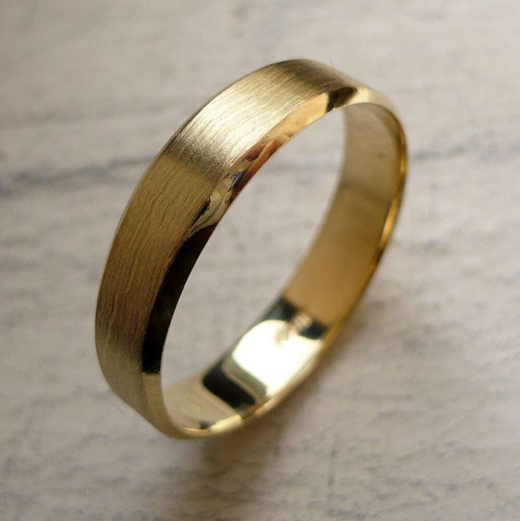 Minimalist brushed gold men’s engagement ring symbolizing modern love and understated style.
