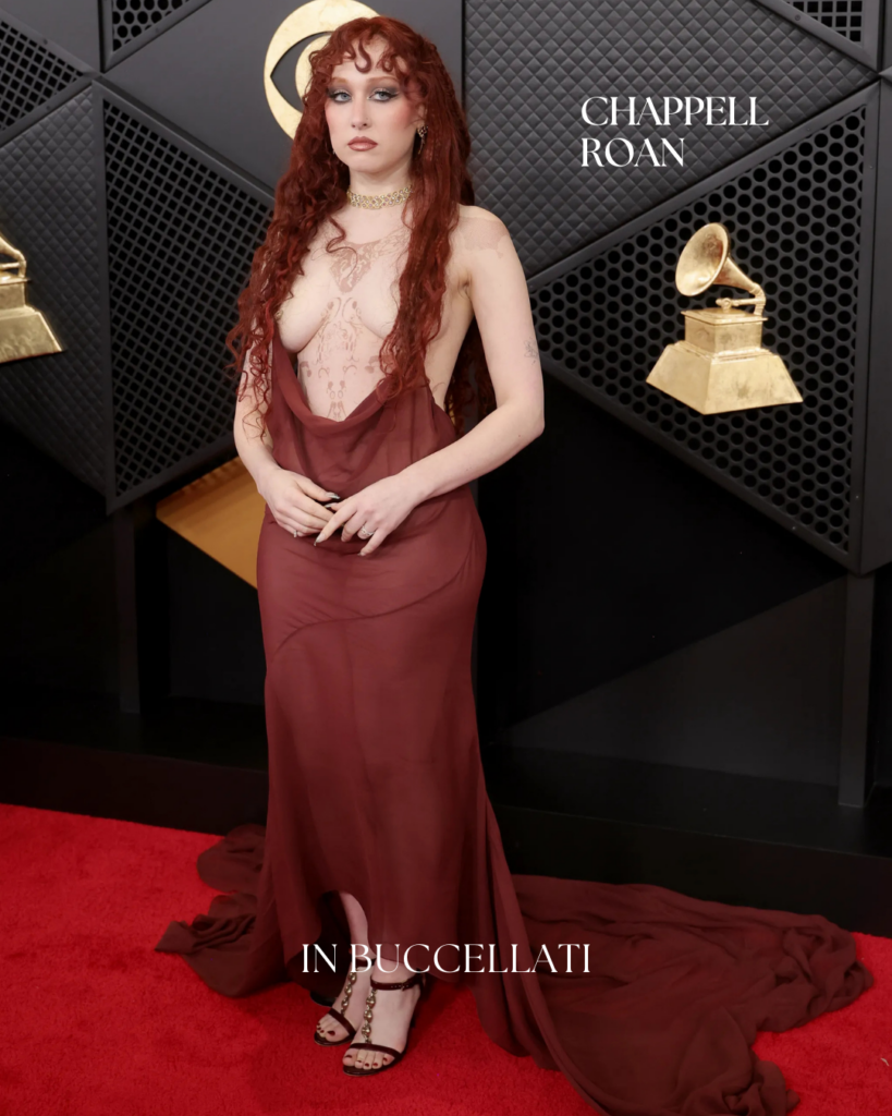Chappell Roan attending the Grammy Awards wearing dramatic statement jewelry, styled with theatrical red carpet fashion and bold glam details.
