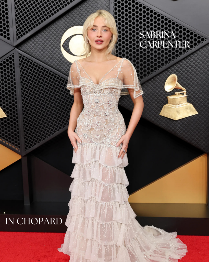 Sabrina Carpenter attending the Grammy Awards in Chopard jewelry, featuring diamond earrings and rings paired with an embellished sheer gown.