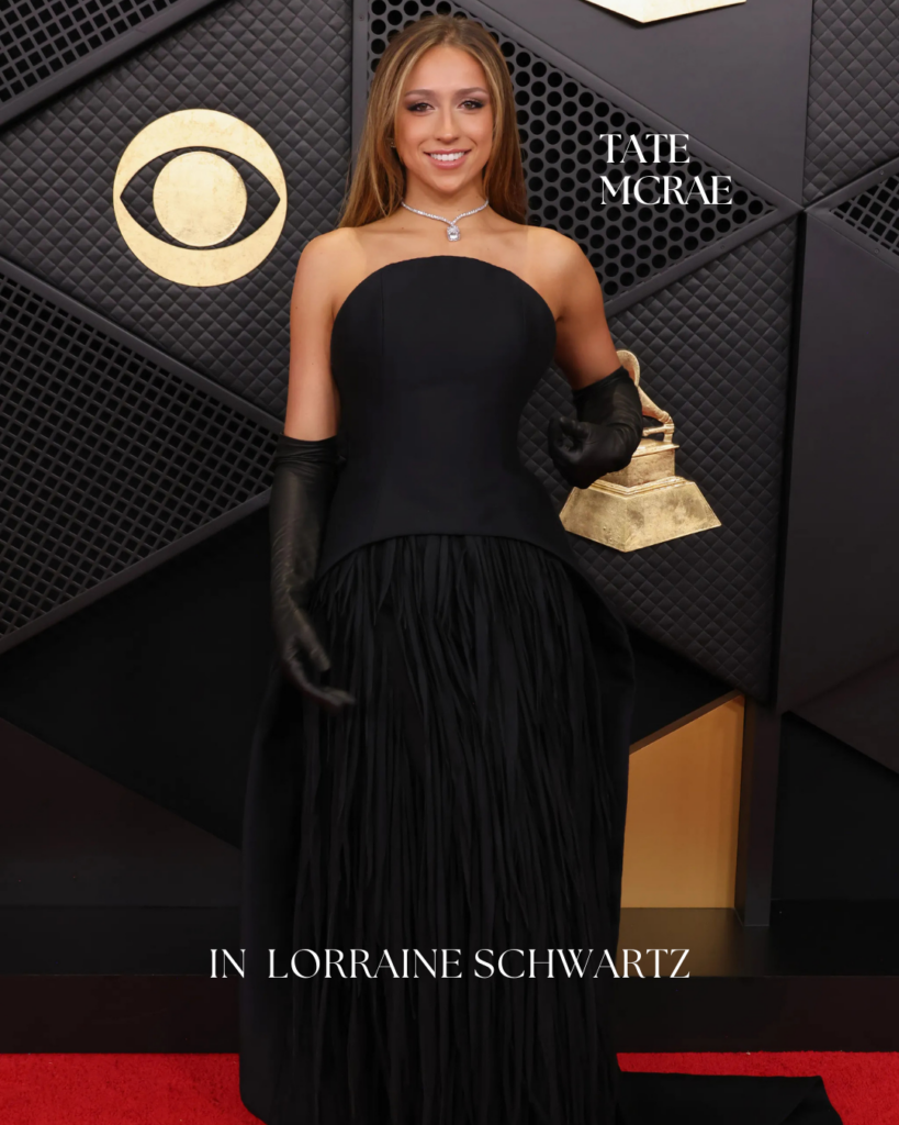 Tate McRae on the Grammy Awards red carpet wearing contemporary diamond jewelry, paired with a sleek modern silhouette and high-fashion styling.
