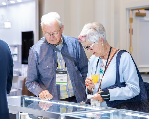  Jewelry buyers and exhibitors at JCK Las Vegas trade show exploring diamond trends, engagement rings, and luxury jewelry collections

