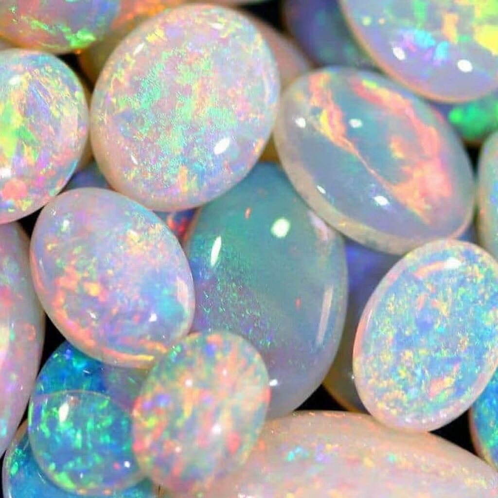 Iridescent opal and colorful tourmaline gemstones for October birthstone in unique jewelry, representing creativity