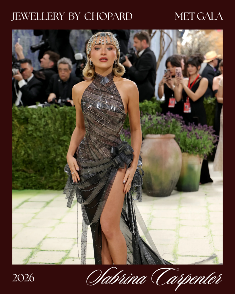 Sabrina Carpenter Met Gala look 2026 wearing Chopard diamond necklace 54 carats draped down back of Christian Dior gown looped through fingers Costume Art red carpet