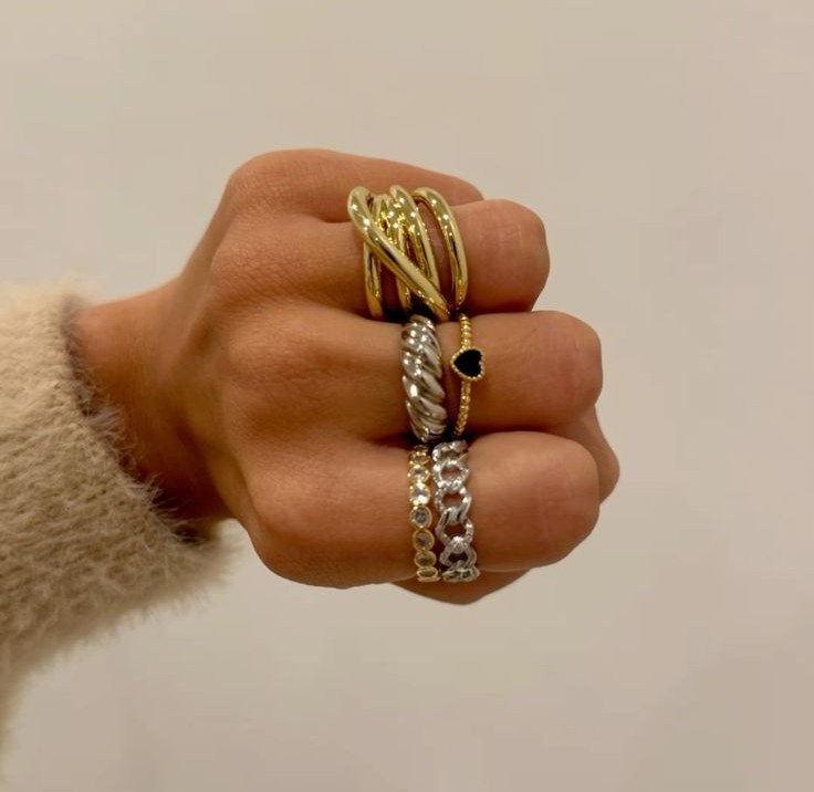 Mixed-metal jewelry combining yellow gold, white gold, and platinum in contemporary rings, bracelets, and layered necklaces.