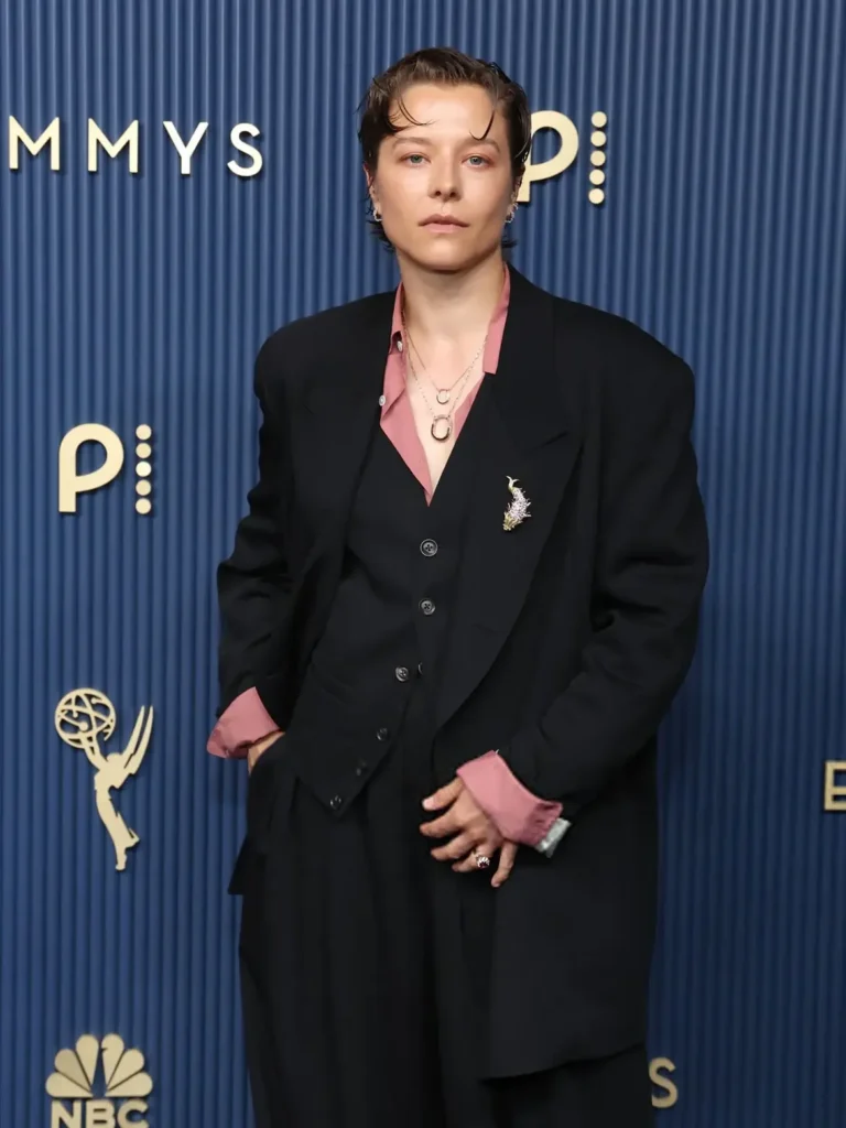 Emma D'Arcy wearing Tiffany & Co. jewelry at the Emmys 2026, featuring contemporary Tiffany Lock pendants accented with pink sapphires and a modern gender-fluid luxury aesthetic.